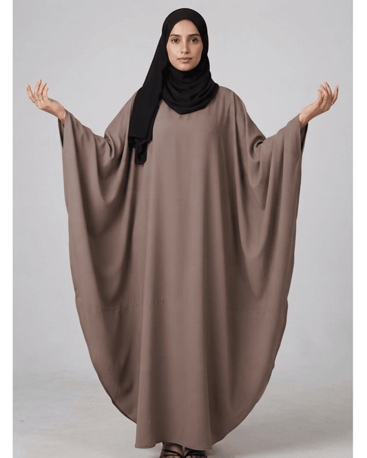 Woman wearing a Zevi Kaftan Abaya in Mocha Taupe by alsaadabaya with a black hijab
