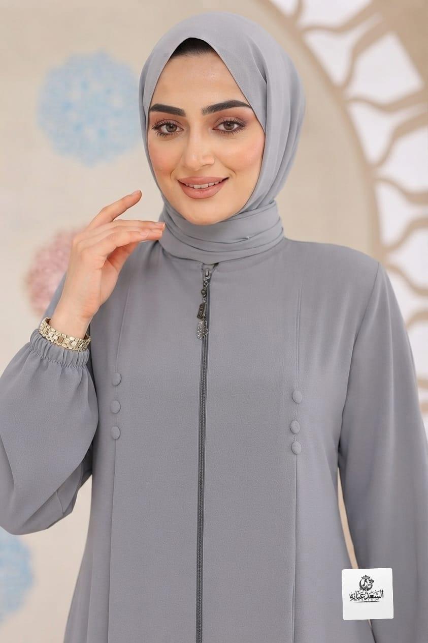 Woman wearing a gray zipped abaya by alsaadabaya with a matching hijab.