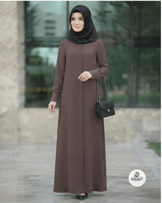 Woman wearing a mocca colored "Hani" Abaya by alsaadabaya with a black hijab and handbag.